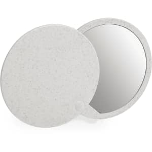 A round, speckled white pocket mirror with a reflective surface, featuring a simple clasp design.