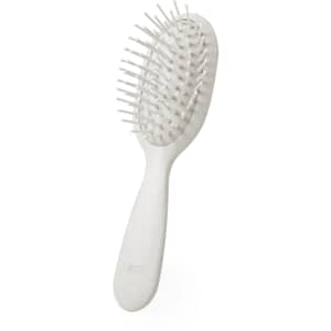 A white hairbrush with a curved handle and wide bristles, featuring a branded logo on the side.