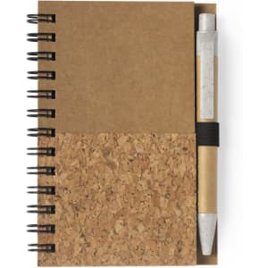 A cork notebook with a brown cover, featuring a spiral binding and a pen secured by an elastic band.