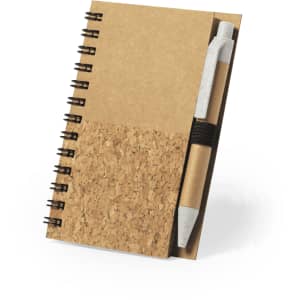A cork and kraft paper notebook with a spiral binding and a pen attached.