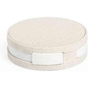 A round, light grey USB hub with a smooth surface and a white connector section. It features a simple and minimalist design.