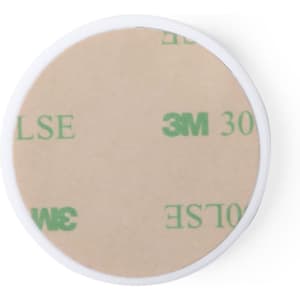 A round adhesive disc with a beige backing, featuring a branding logo. The disc is encased in a white border.