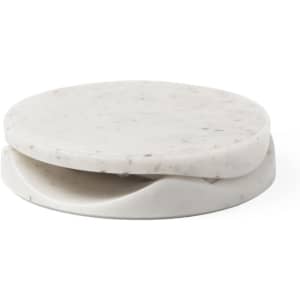 A marble phone stand in white with grey speckles. The design features a smooth circular top and a slot for stability.