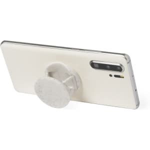 A white phone stand with a circular holder attached to the back of a silver smartphone, featuring a logo.