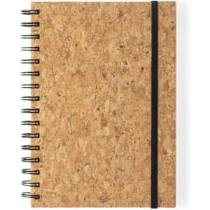 A cork notebook with a spiral binding and a black elastic band, featuring a natural textured cover.