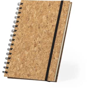 A cork-covered notebook with a black elastic band and wire spiral binding.