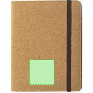 A tan notepad with a brown elastic band, featuring a green patch on the front for branding or customisation.