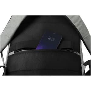 A grey and black backpack with a smartphone visible inside a pocket. The backpack features multiple compartments.