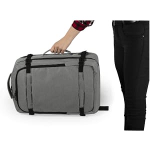 A grey Sulkan Document Bag Backpack with handles and straps, alongside a person's hand and black jeans.
