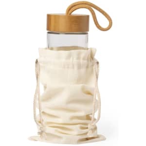 A drink bottle with a wooden lid housed in a cream-coloured drawstring bag. The bag has a rope handle and branding.
