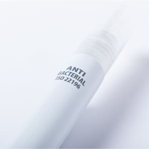 A white multifunction antibacterial pen with a clear cap and a logo.