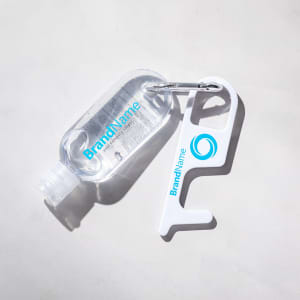 A clear drink bottle with a white antibacterial keyring tool attached, featuring a logo.