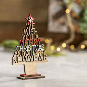 A wooden decorative Christmas tree in natural and red colours, featuring festive greetings. Includes a star on top.