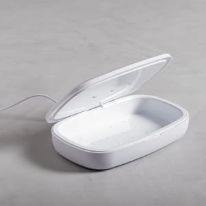 A white UV sterilizer box with an open lid, featuring a sleek design and internal compartments.