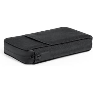 A black organiser with a textured fabric exterior and a smooth base, featuring a zip closure on one side.
