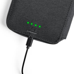 A black UV sterilizer organizer with a charging cable and indicator lights.