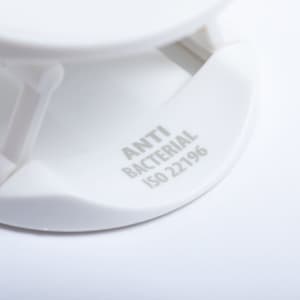 A white antibacterial phone holder with a sleek design and a logo visible on the base.