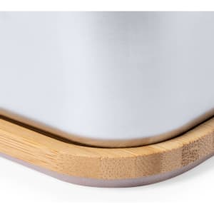 A sleek silver lunch box with a bamboo base and a subtle rounded edge, featuring a simple design.