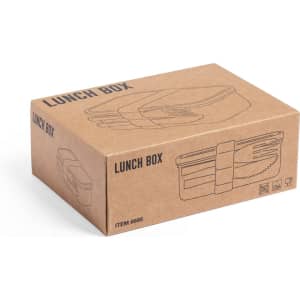 A brown cardboard box containing an illustrated lunch box, featuring a simple design and a logo.