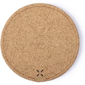 A round, natural cork wireless charger with textured finish and subtle stitching details.