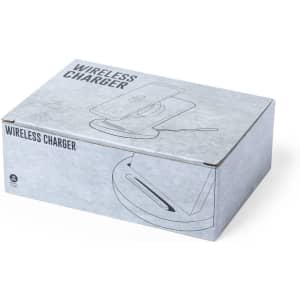 A grey box containing a wireless charger, featuring a logo and simple design elements on the packaging.