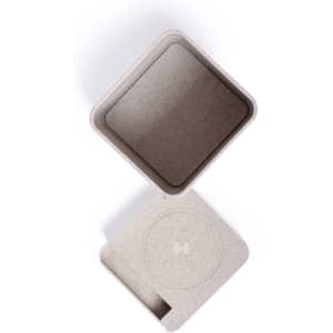 A square, light beige pencil holder with a flat lid, featuring a circular design on top and a smooth finish.