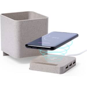 A beige pencil holder with a wireless charging pad and a smartphone placed on it, featuring USB ports.