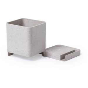 A grey square pencil holder with a removable lid and a base. Features a branding logo.