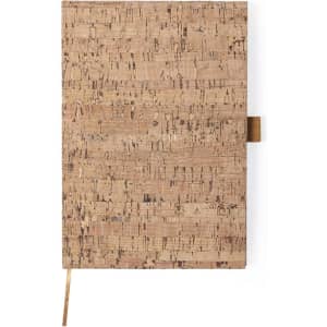 A cork-covered notepad with a textured surface and a ribbon bookmark, showcasing natural brown tones.