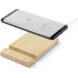 A wireless charger with a wooden base and a smartphone positioned above it, showcasing charging indicators on the screen.