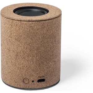 A cylindrical speaker with a cork exterior and a black speaker grille. It features a power button and a USB port.