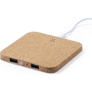 A wireless charger with a cork finish, featuring two USB ports and a cable attached.