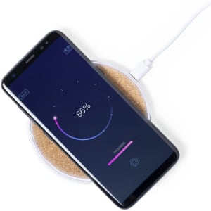 A wireless charger in a round shape with a smartphone displaying a charging progress bar. The charger has a light-coloured base.