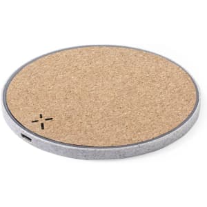 A round wireless charger with a cork top and a silver metal edge, featuring a small logo.