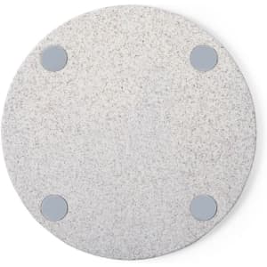 A round, light grey wireless charger with four non-slip pads at the base. Features a subtle texture throughout.