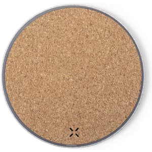 A circular wireless charger with a cork surface and a silver edge, featuring a discreet logo.