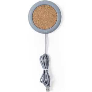 A wireless charger with a grey edge and a cork surface, featuring a connected USB cable.