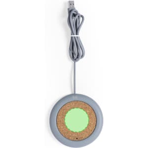 A wireless charger featuring a grey circular design with a cork surface and a connected USB cable.