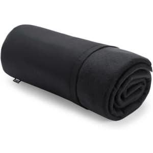 A rolled-up black blanket featuring a smooth outer layer and a soft inner texture, with a small logo on the side.