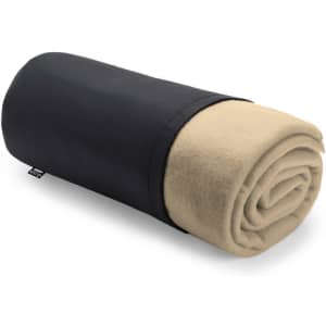 A rolled blanket in beige fleece with a black storage cover, featuring a small logo.