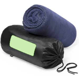 A navy blue blanket rolled and stored in a black pouch with a pull string, featuring a blank space for branding.