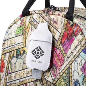 A hand sanitiser pouch in white attached to a colourful, patterned bag, featuring a logo on the pouch.