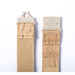Two natural-coloured lanyards made from cork material, featuring different types of clips at the ends.