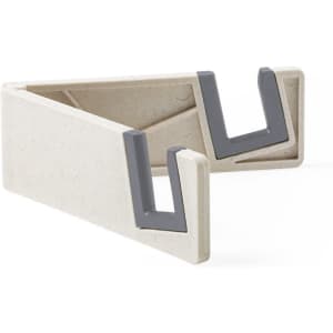 A phone stand in a cream colour with grey accents, featuring a minimalist triangle design and a logo.