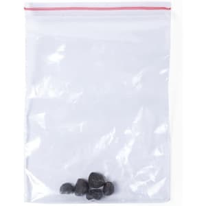 A clear plastic bag containing several small black stones. The bag features a red ziplock closure.