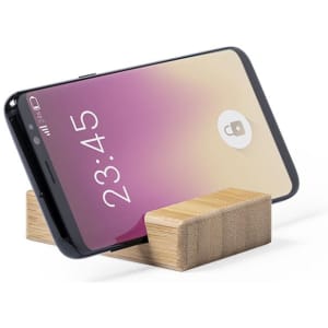 A phone stand in a wooden finish, securely holding a smartphone at an angle. The phone displays a lock screen.