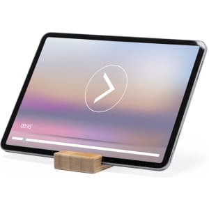 A wooden phone stand supporting a tablet, angled to display a screen with a play bar and time indicator.