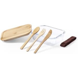 A clear lunch box with a bamboo lid, accompanied by wooden cutlery and a brown strap.