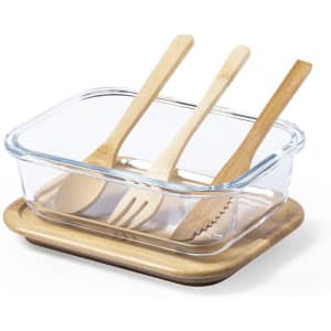 A glass lunch box with a wooden base, containing three wooden utensils: a spoon, fork, and knife.
