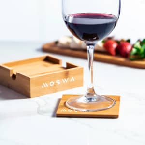 A bamboo coaster set in natural tones, featuring a coaster under a wine glass, alongside a wooden storage box.